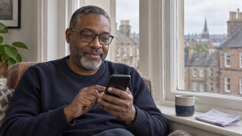 A member using a credit union mobile app to check their savings balance