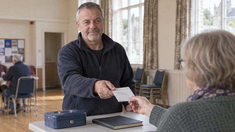 A member paying into their share account at a credit union service point