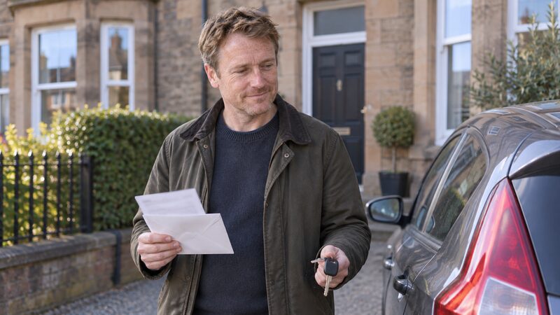 A car with a finance agreement document and a settlement figure letter